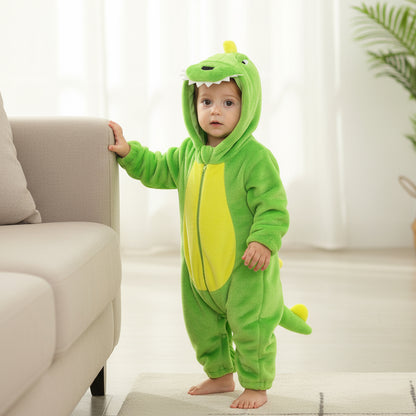 Child wearing a green dinosaur onesie in a living room.
