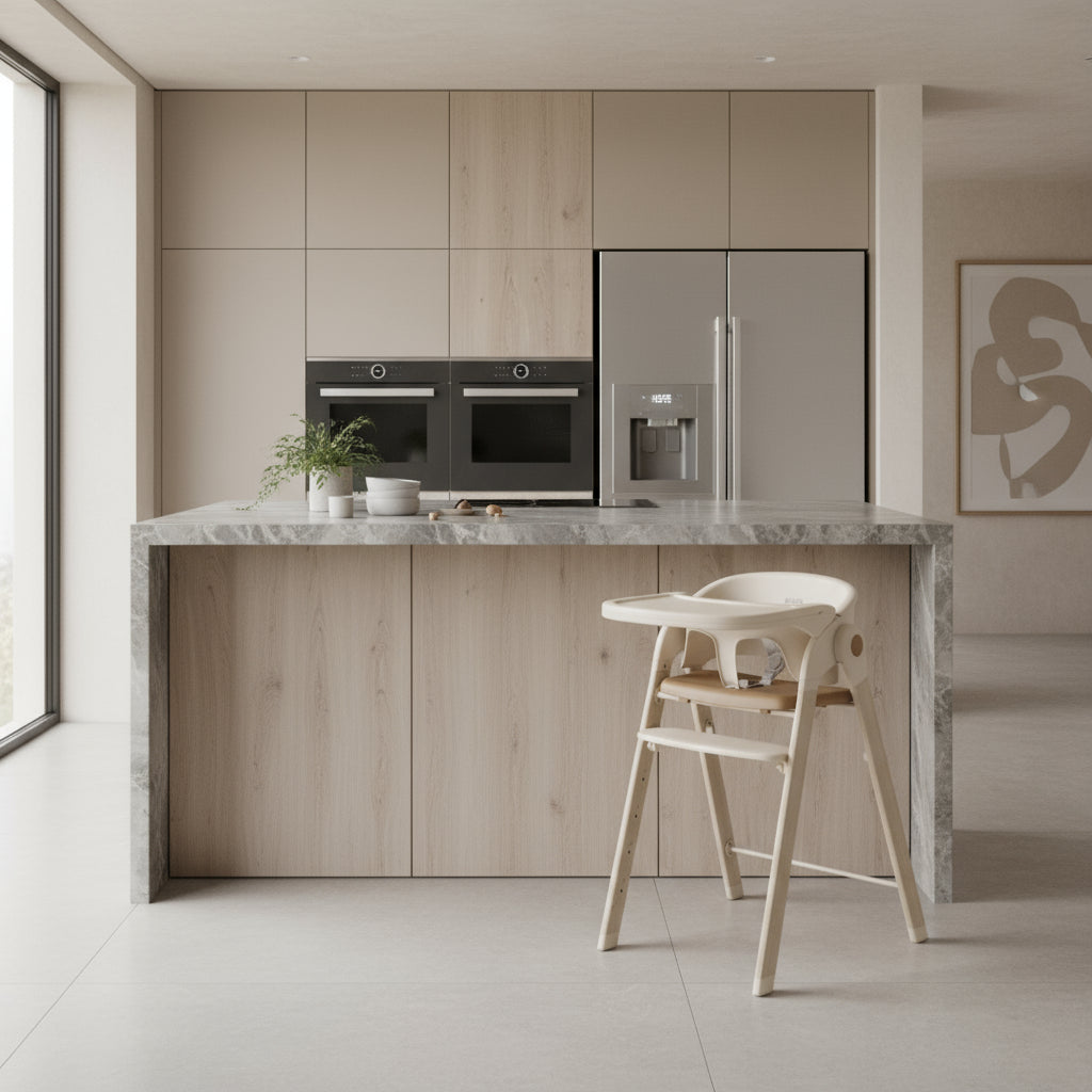 Modern kitchen with wooden cabinets, marble countertop, and high chair.