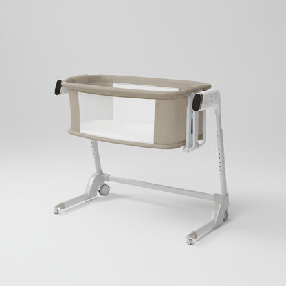 Portable baby crib with beige cover on a white background