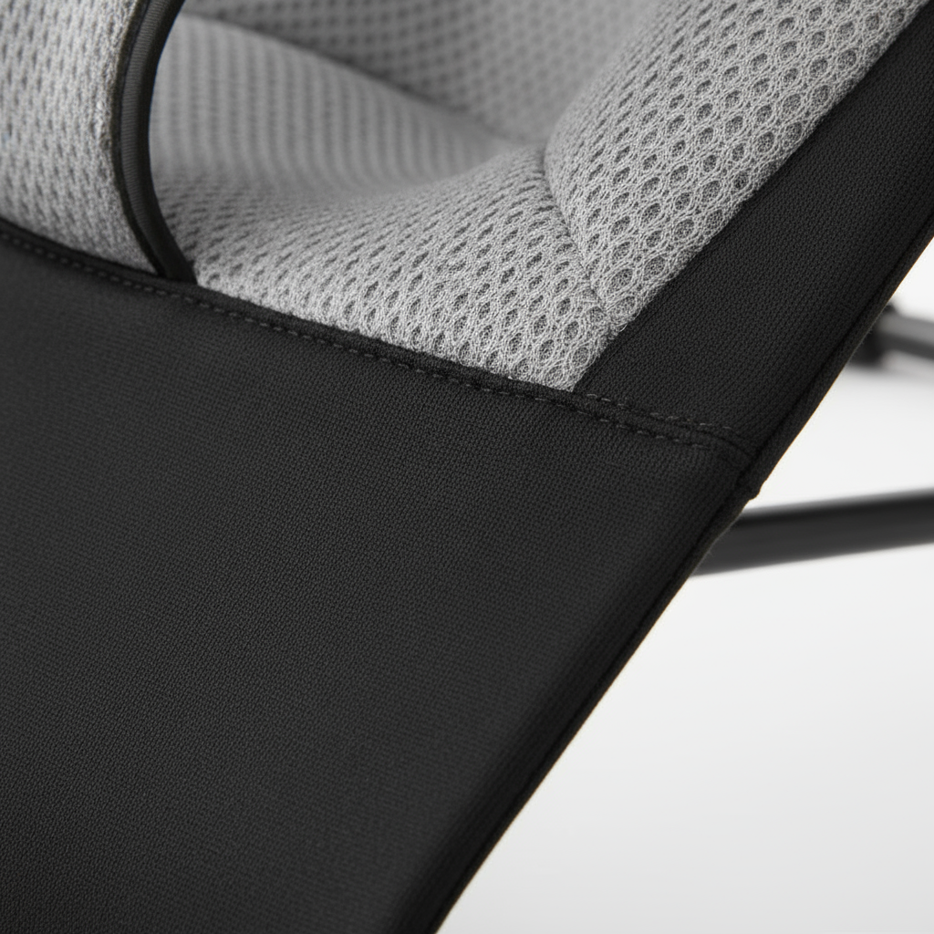 Close-up of a chair with black and gray mesh design on a light background