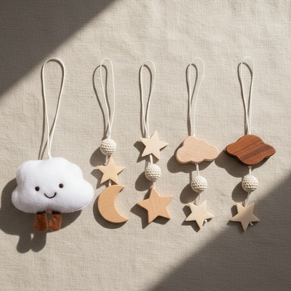 Set of decorative hanging charms including a cloud, stars, and moons on a neutral background.