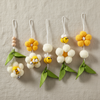 Set of felt flower and bee decorations on a beige background