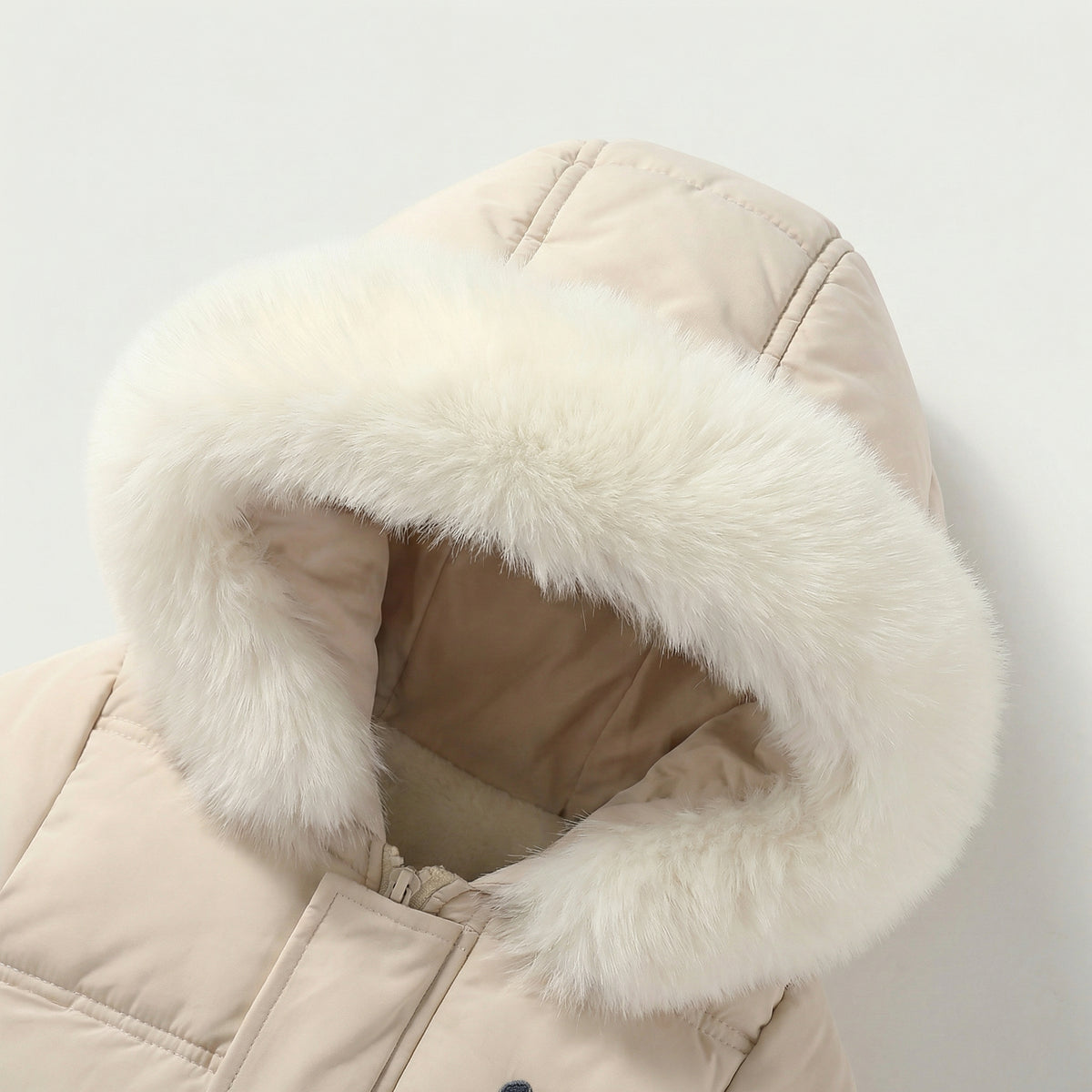 Beige winter coat with white fur hood on a light gray background