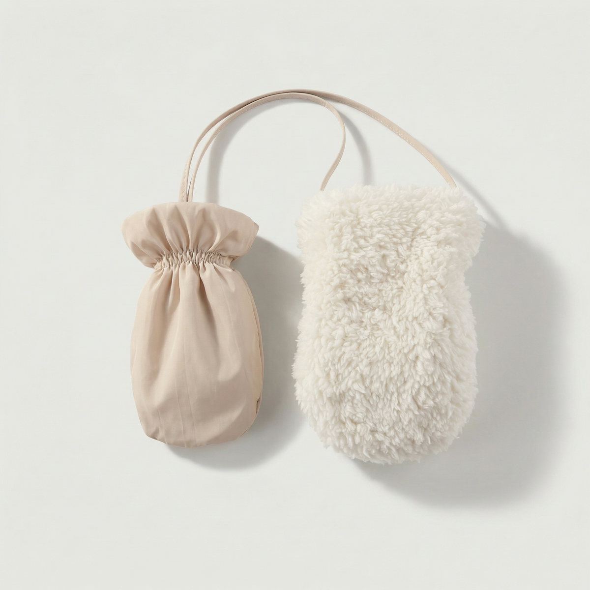 Beige drawstring bag and white fluffy pouch on a light gray background