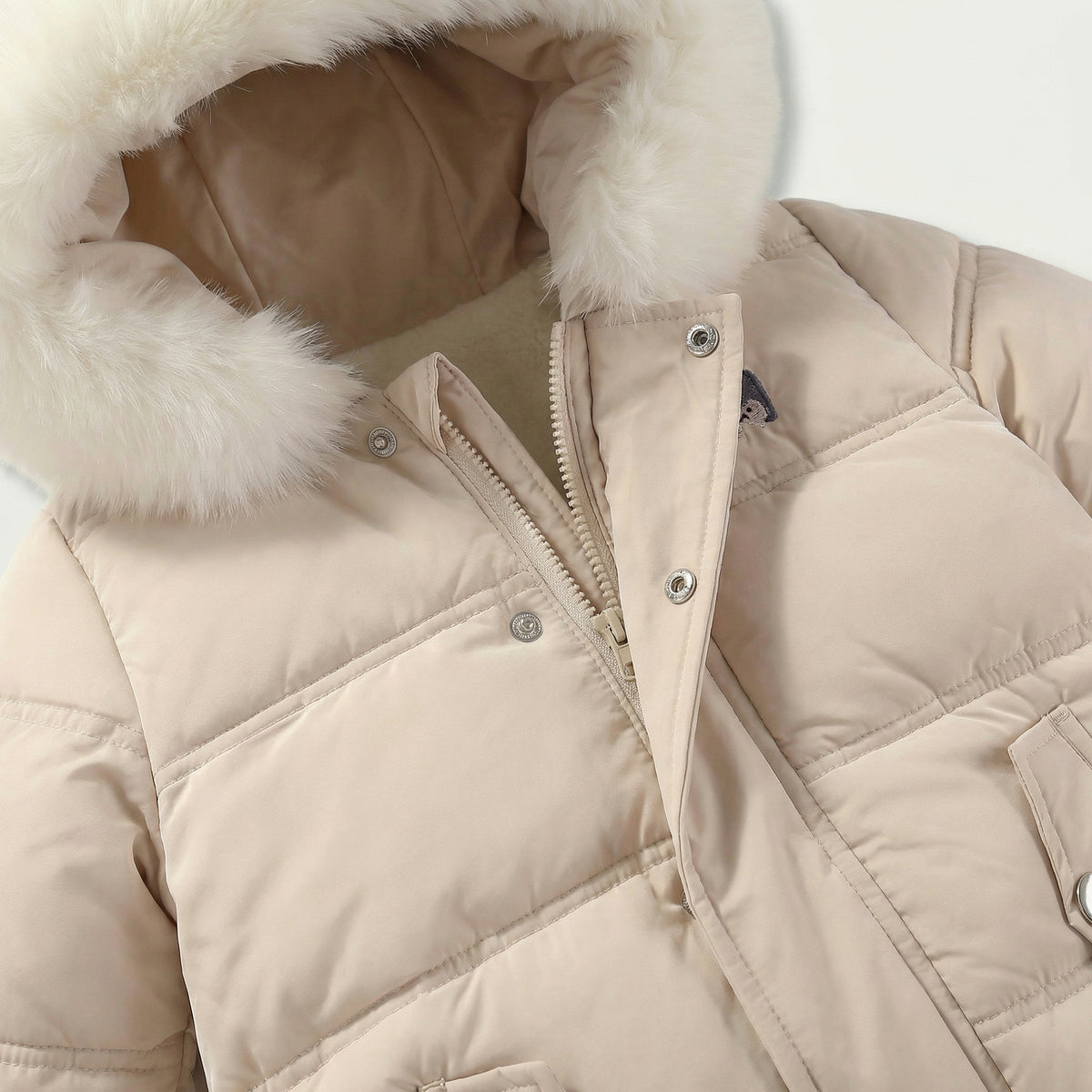 Beige puffer jacket with fur-lined hood on a light gray background