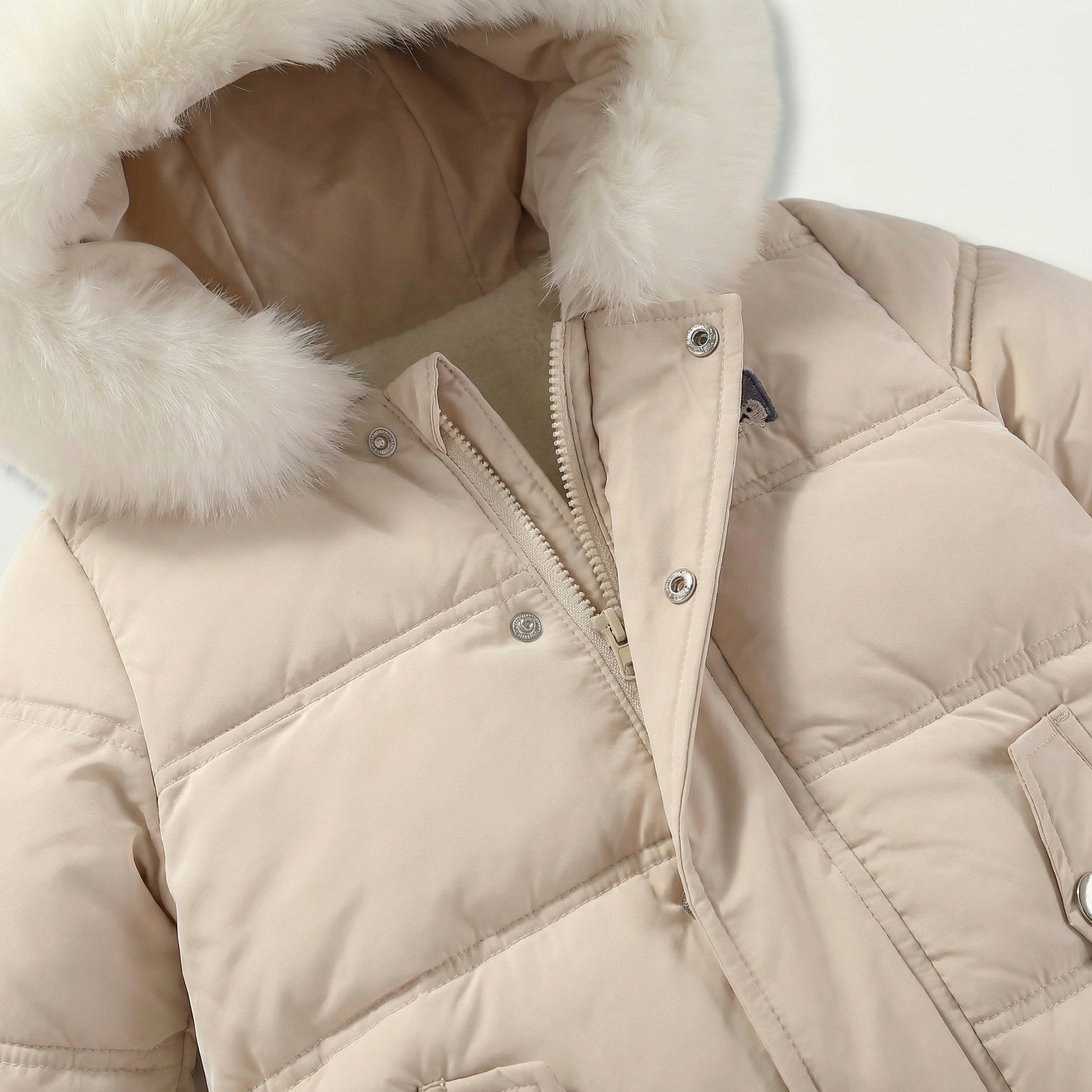 Beige puffer jacket with fur-lined hood on a light gray background