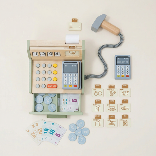 Toy cash register with calculator, money, and food items on a light background
