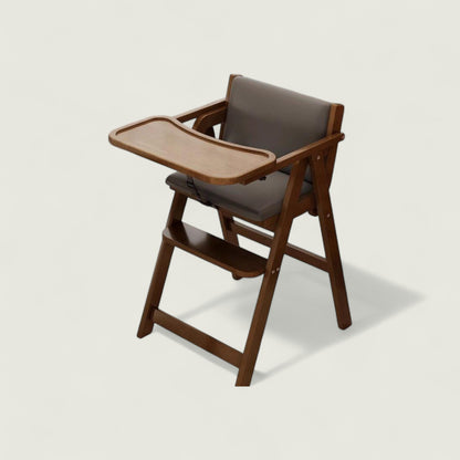 Wooden high chair with a tray on a light beige background