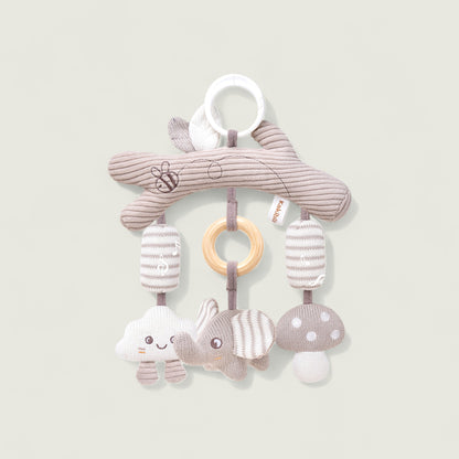 Baby mobile toy with soft animals and rings on a light background