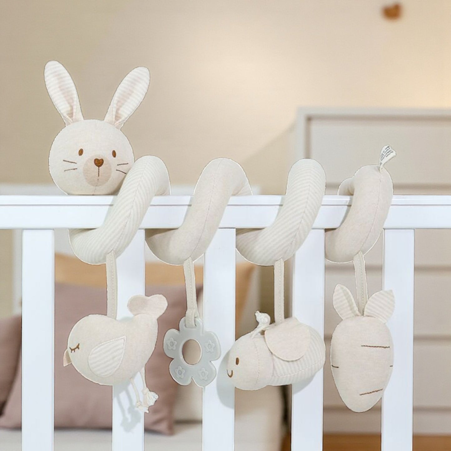 Baby crib mobile with hanging plush toys in a nursery setting