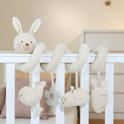 Baby crib mobile with hanging plush toys in a nursery setting