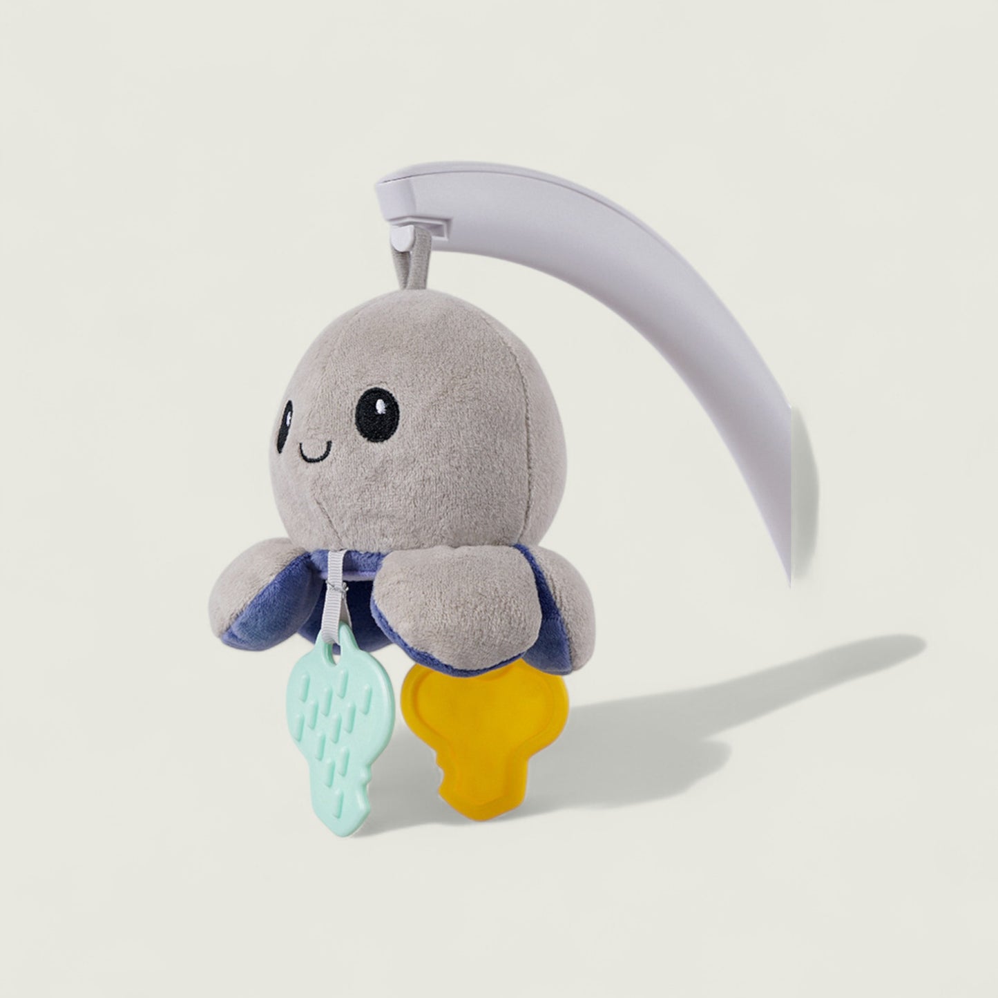 Gray plush toy with a smiley face on a white background