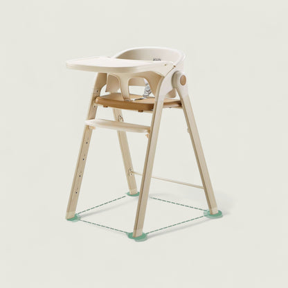 Children's high chair with white seat and wooden legs on a light gray background