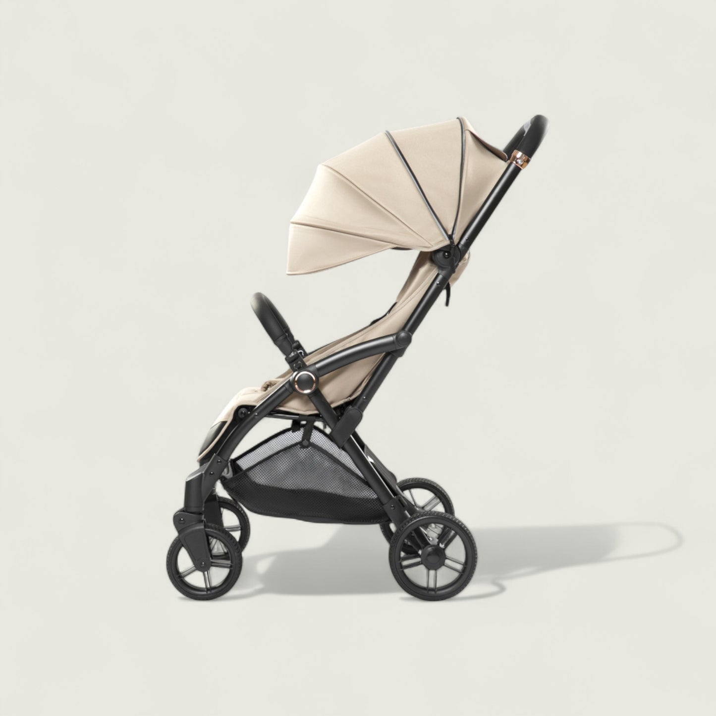 Beige and black stroller on a light gray background
