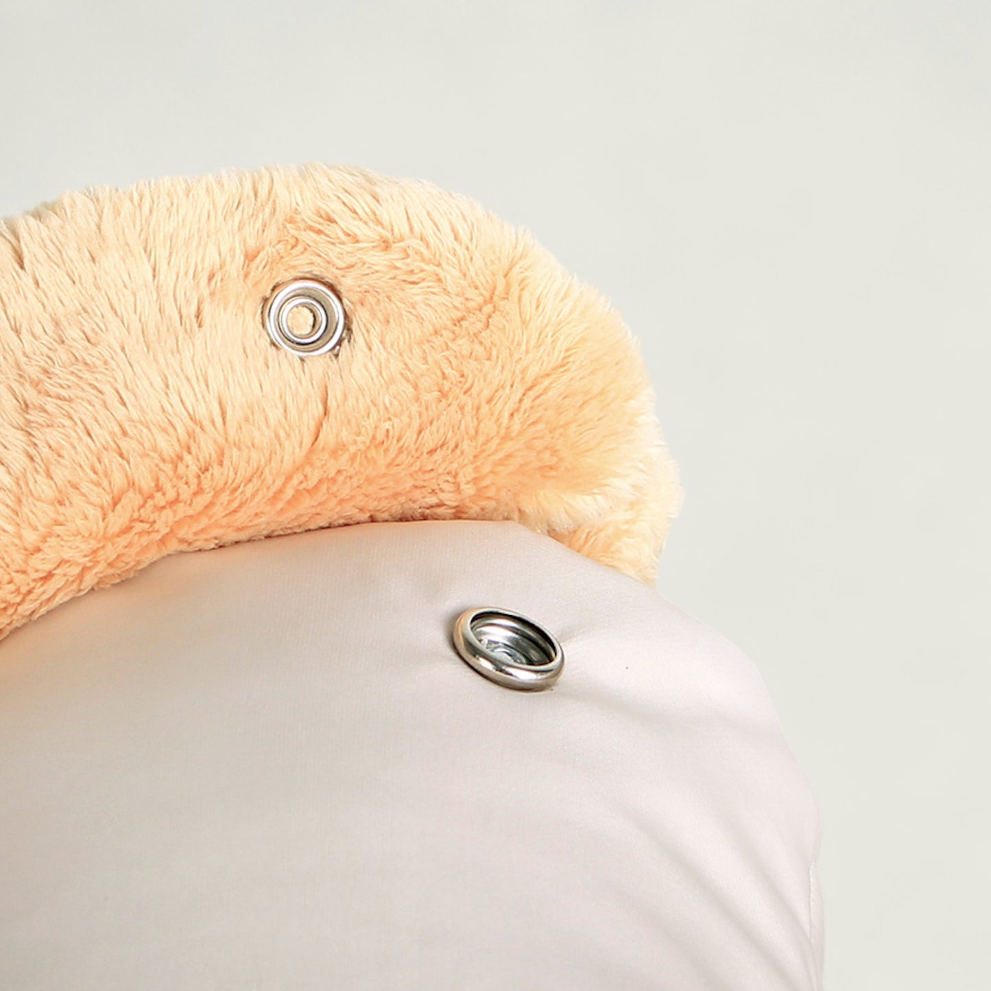 Close-up of a plush flamingo toy with a light gray background