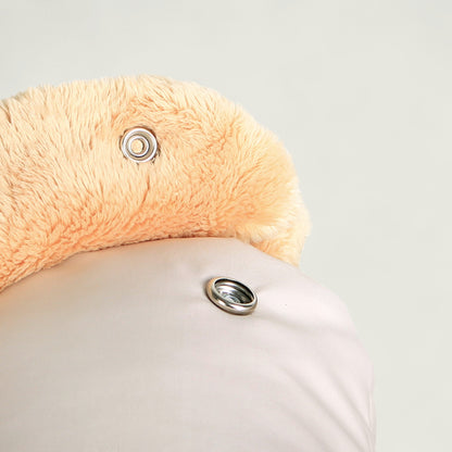 Close-up of a plush flamingo toy with a light gray background