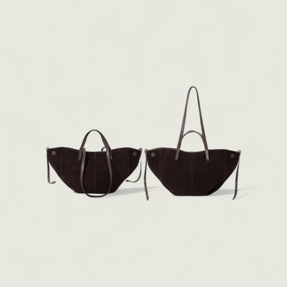 Two brown handbags with handles on a light gray background