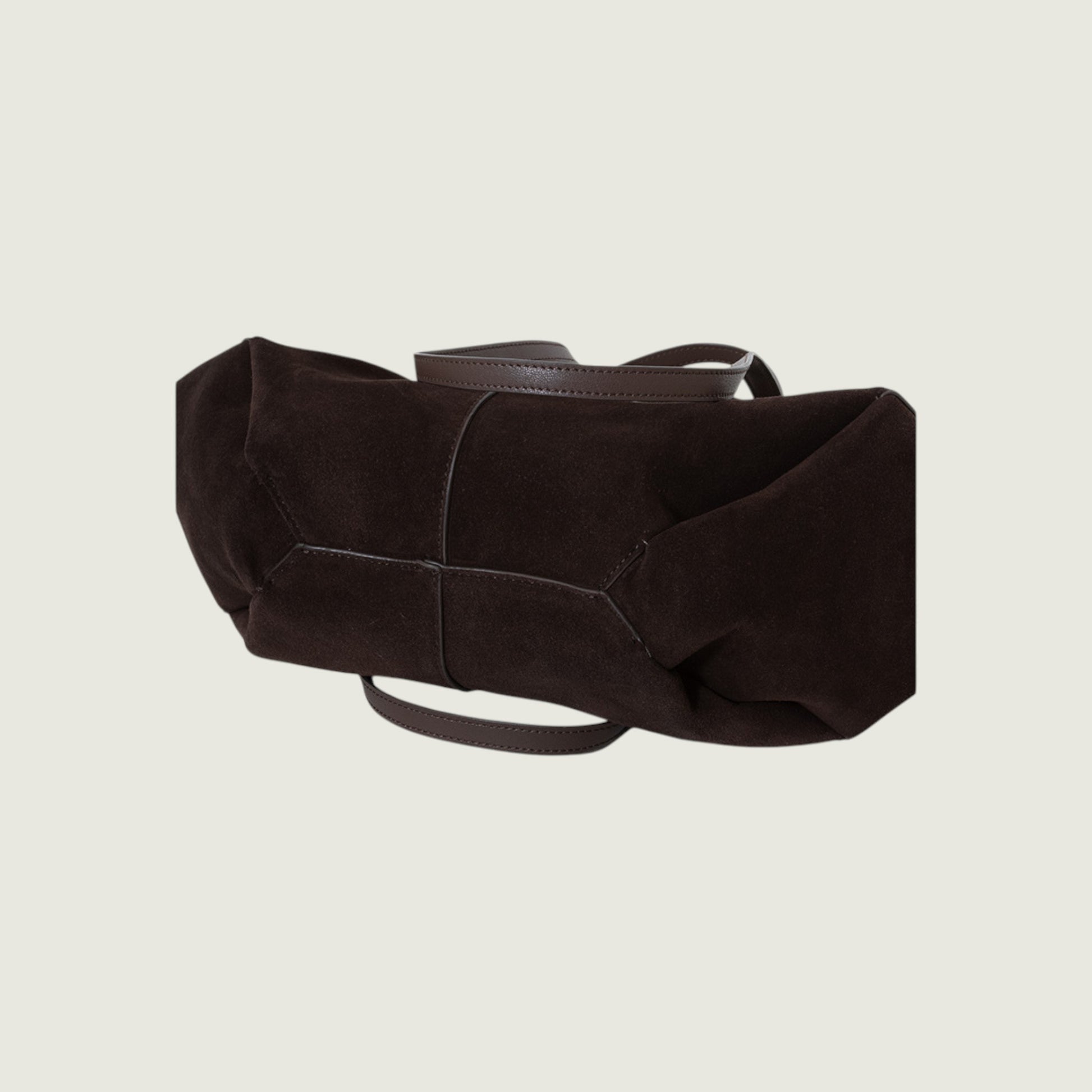 Dark brown leather belt on a light beige background