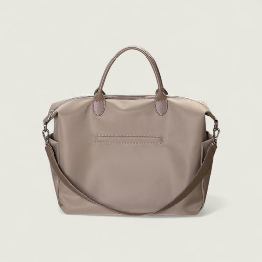 Brown handbag with a shoulder strap on a light beige background