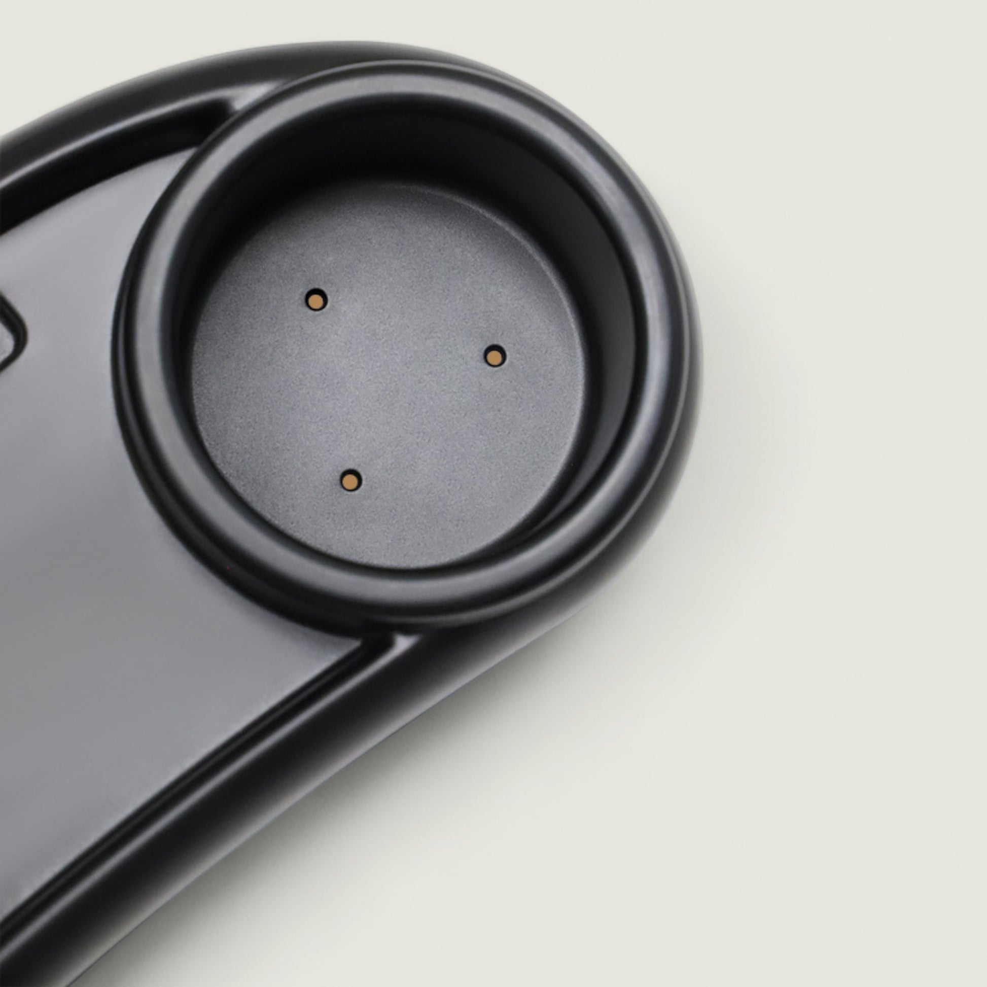 Close-up of a black electronic device on a light gray background