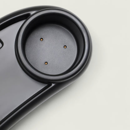 Close-up of a black electronic device on a light gray background