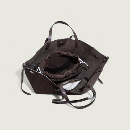 Brown leather handbag on a light beige background