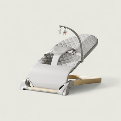 White baby bouncer with quilted design on a light gray background