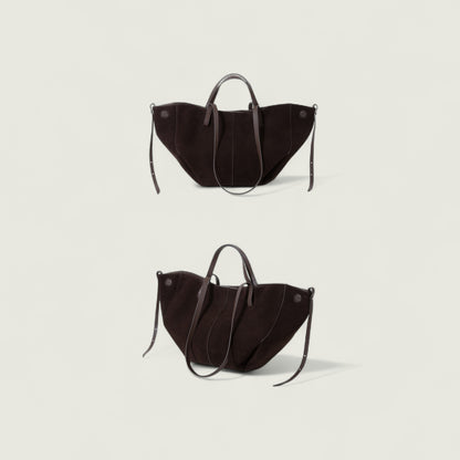 Two black handbags on a light gray background