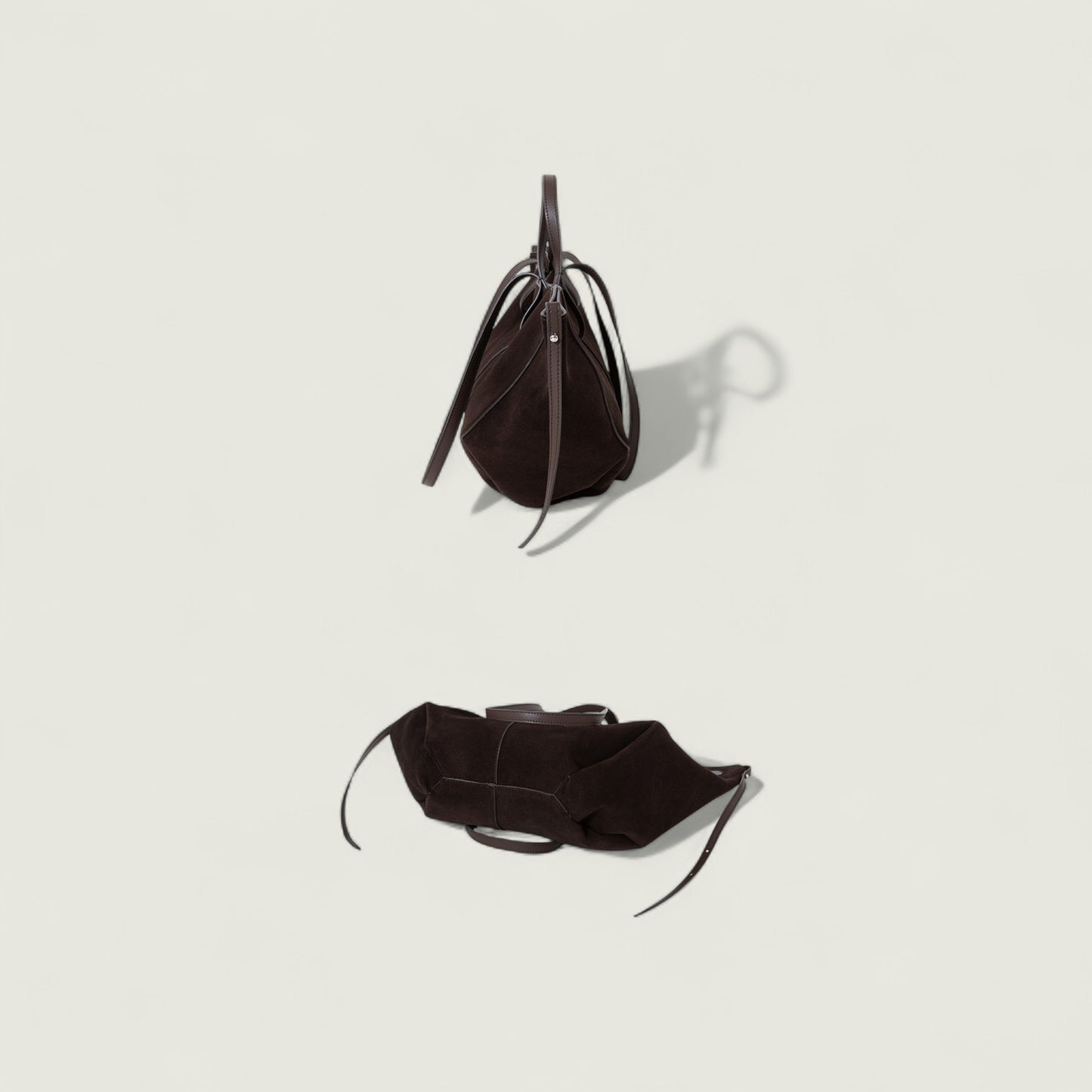 Black leather handbag on a light gray background