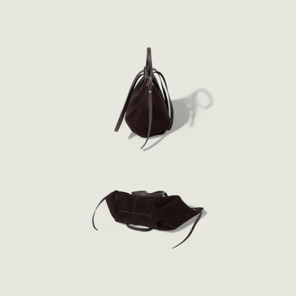 Black leather handbag on a light gray background