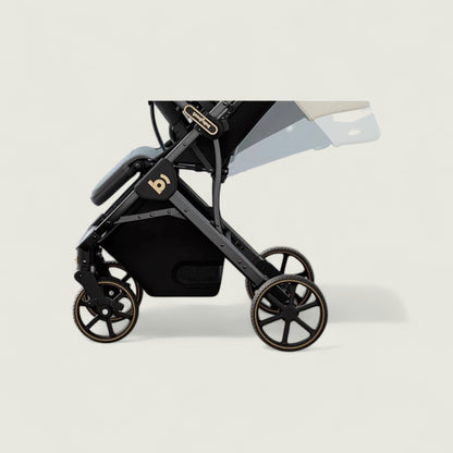 Black stroller with gold accents on a light gray background