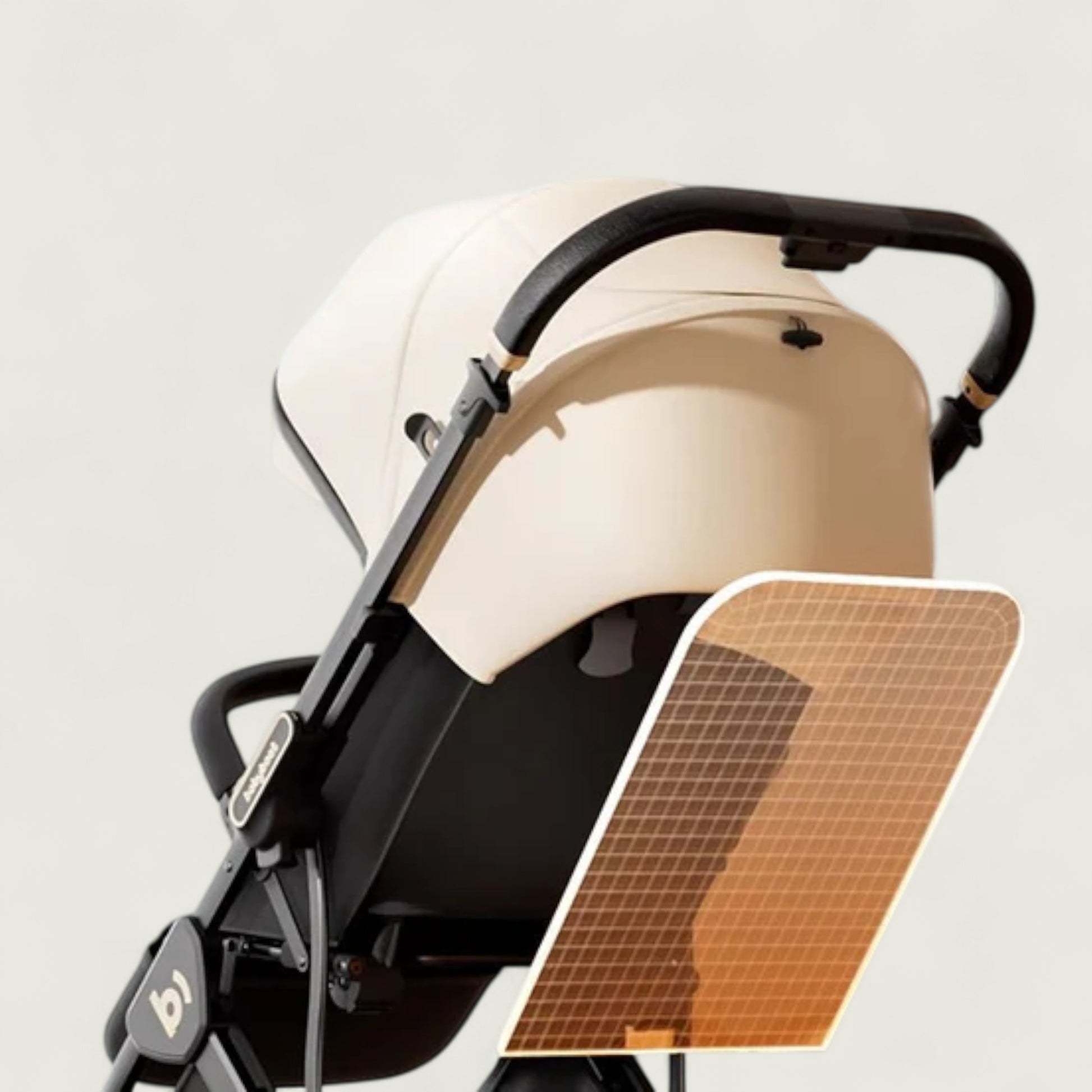 Beige and black baby stroller with a sunshade on a light gray background