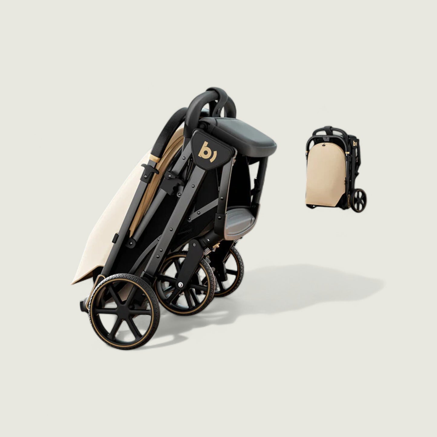 Black and beige stroller with folded accessory on a light background