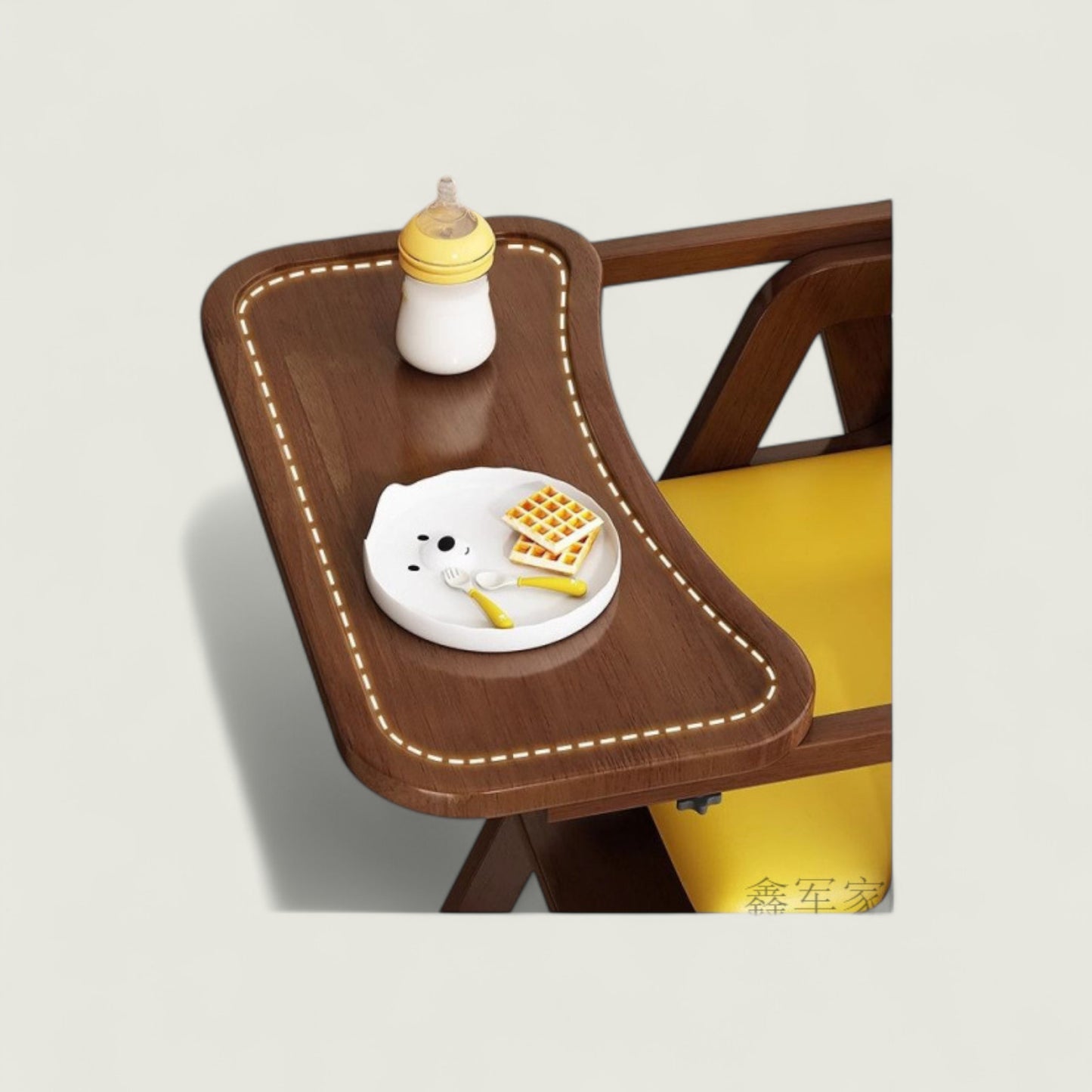 Wooden high chair with a tray, bottle, and plate of food on a light gray background