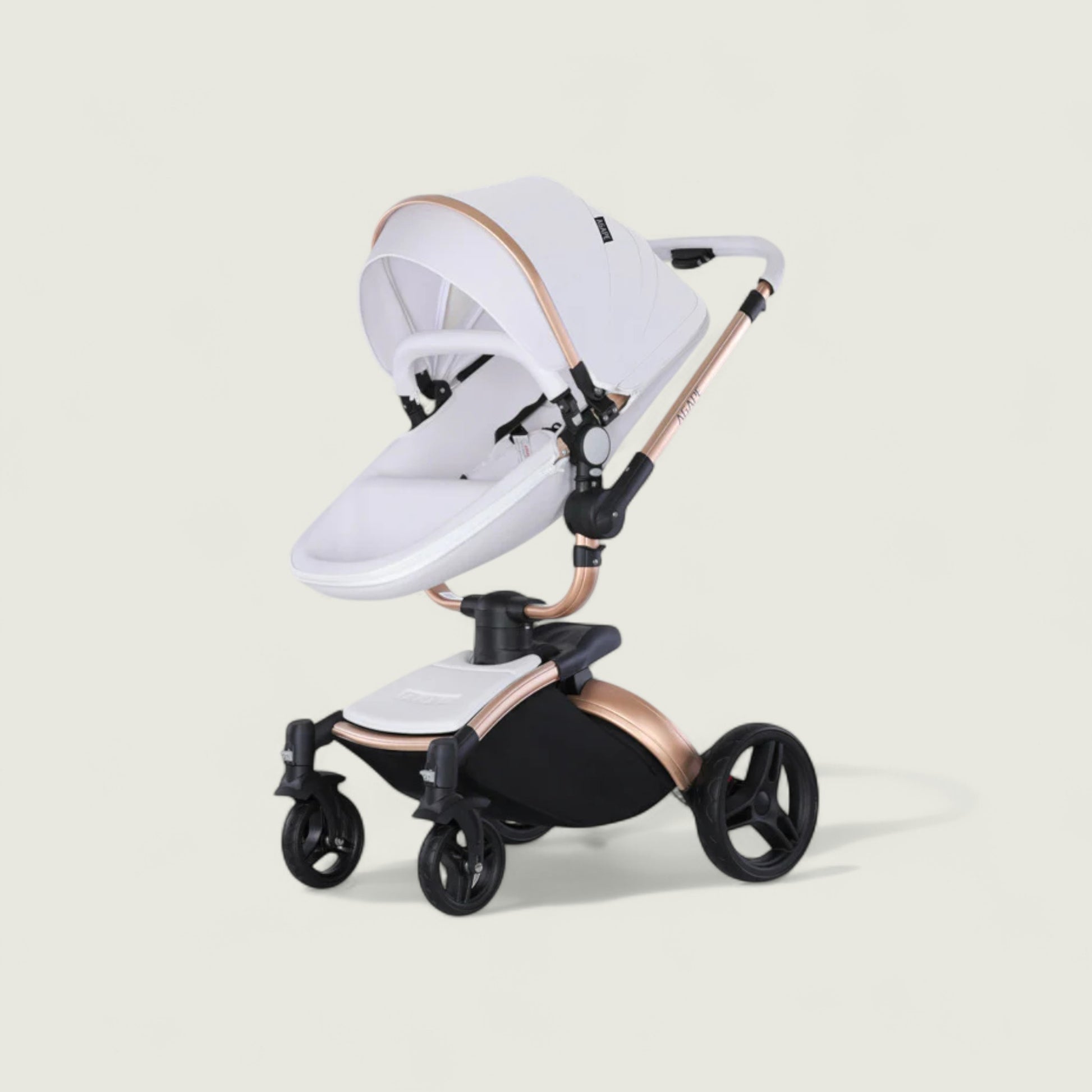 White and rose gold baby stroller on a beige background