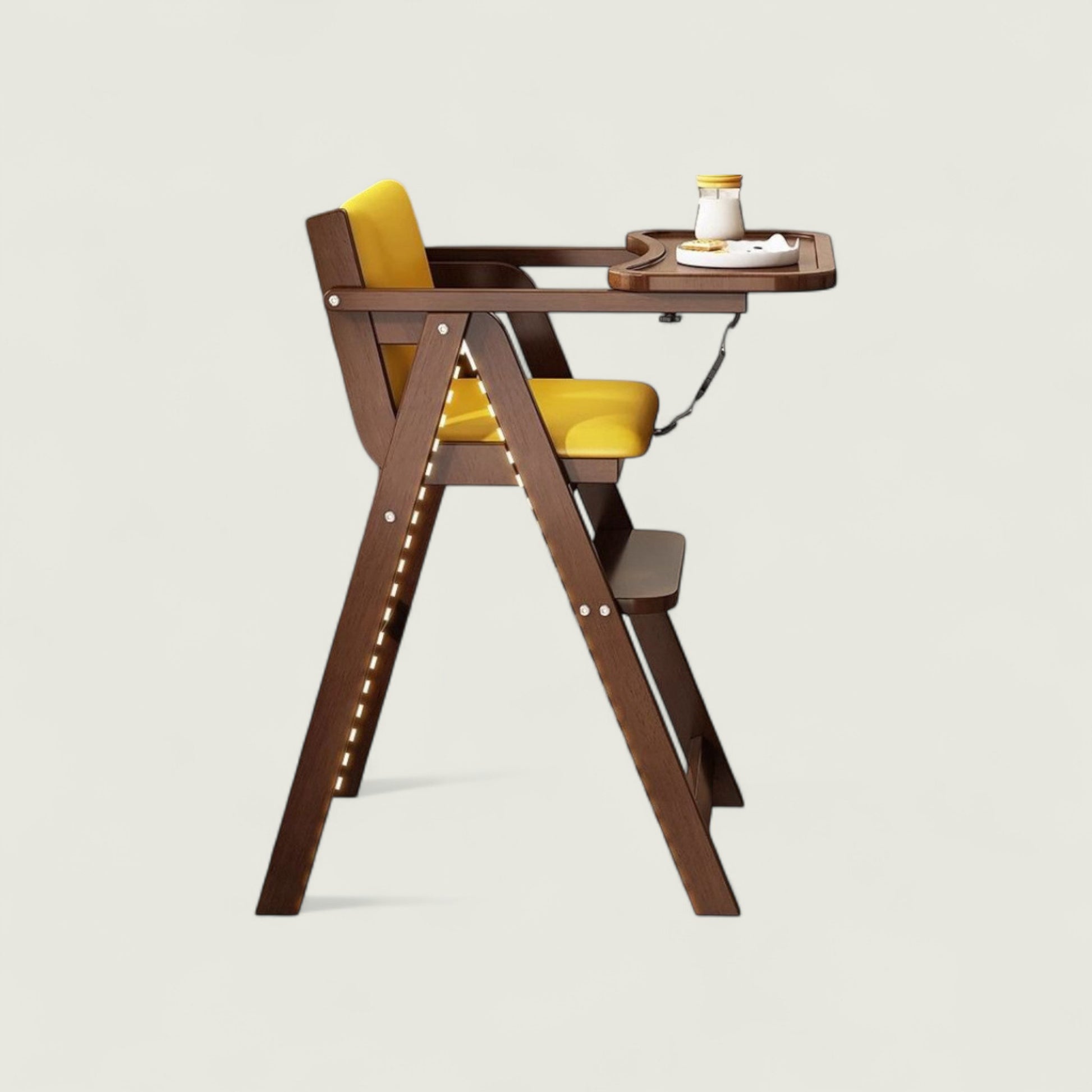 Wooden high chair with yellow cushion on a light gray background