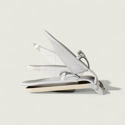 White hair straightener on a light gray background