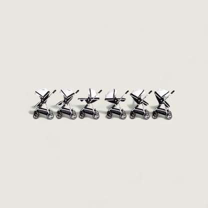 Set of six small metal stroller models arranged in a row on a light gray background