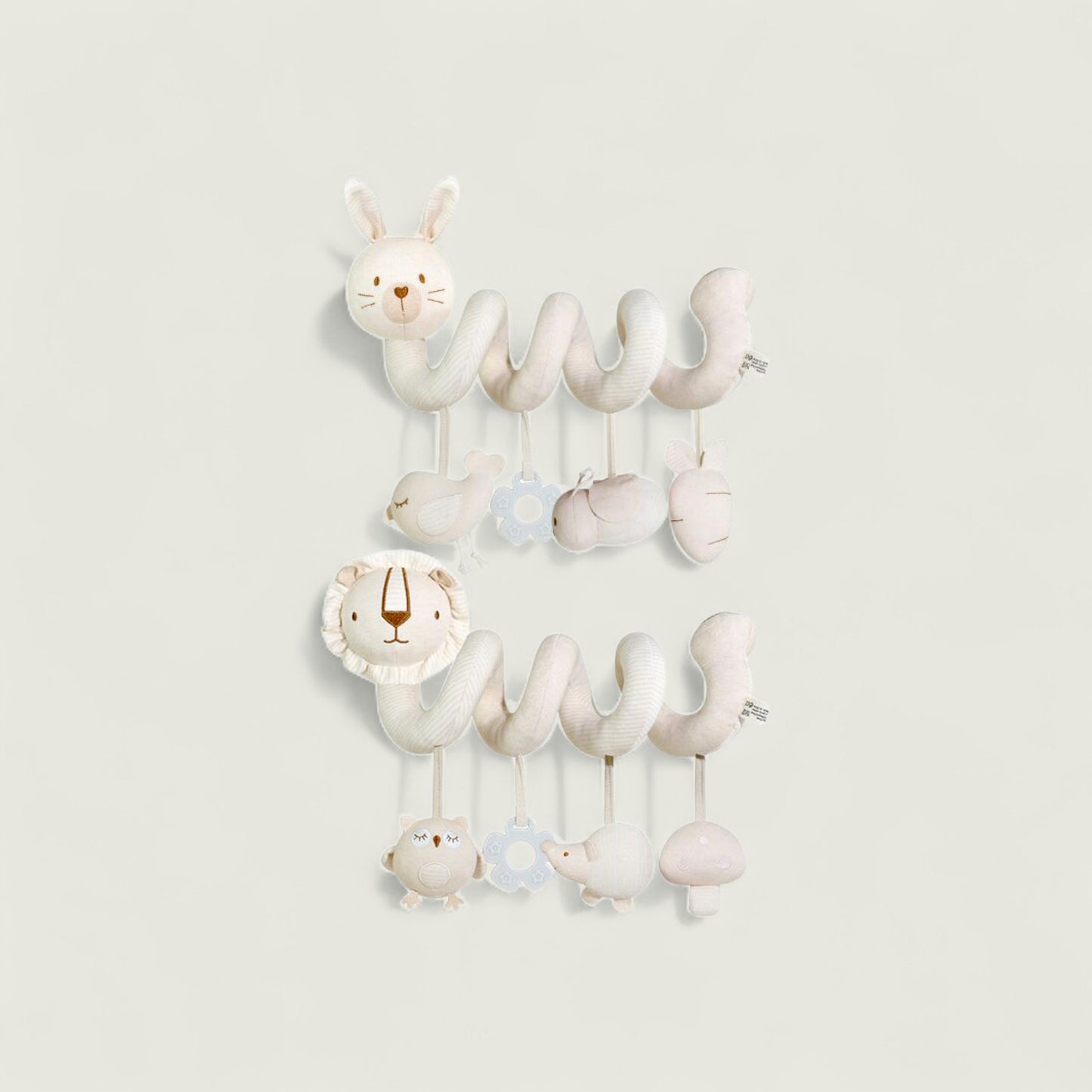 Children's mobile with hanging animal toys on a light gray background