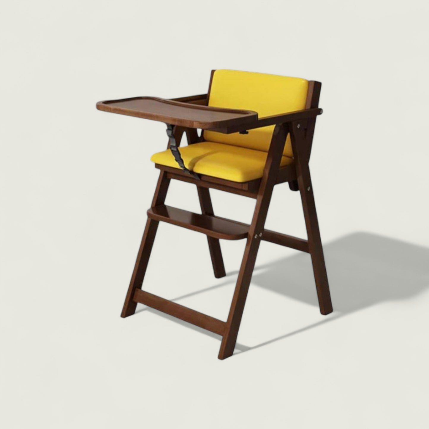 Wooden high chair with yellow cushion on a light background