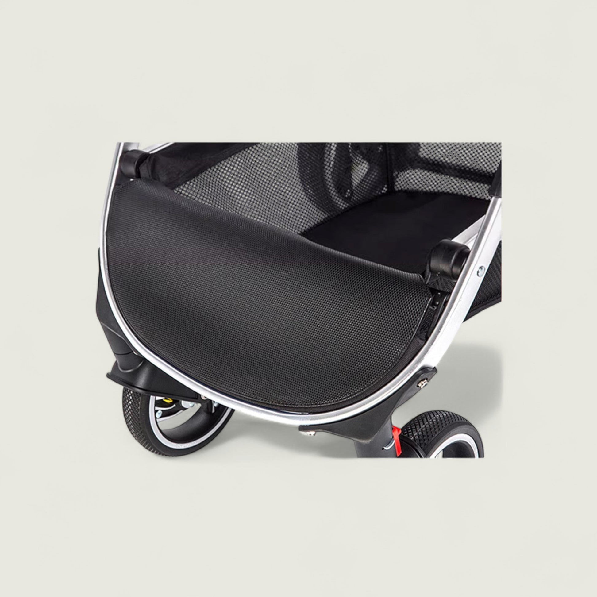Close-up of a black pet stroller on a light gray background