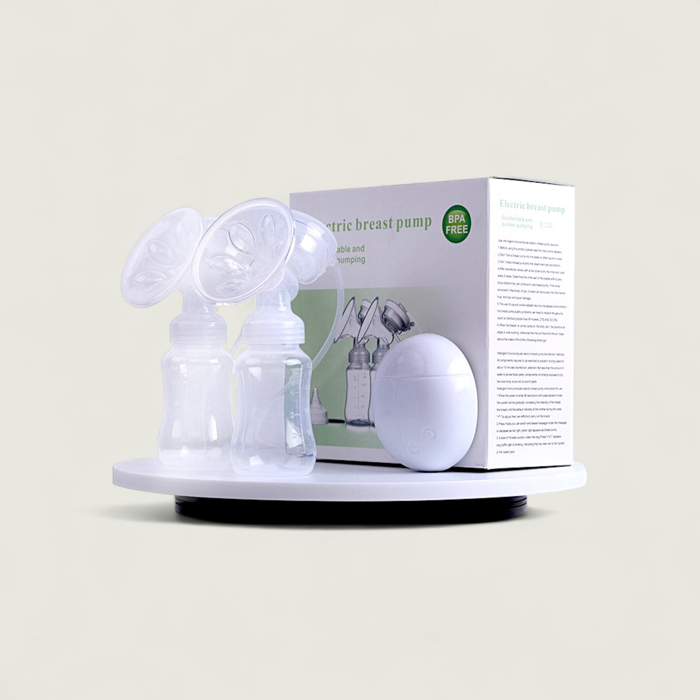 Electric breast pump with packaging on a beige background