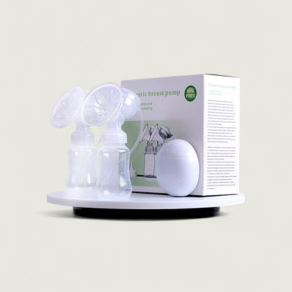 Electric breast pump with packaging on a beige background