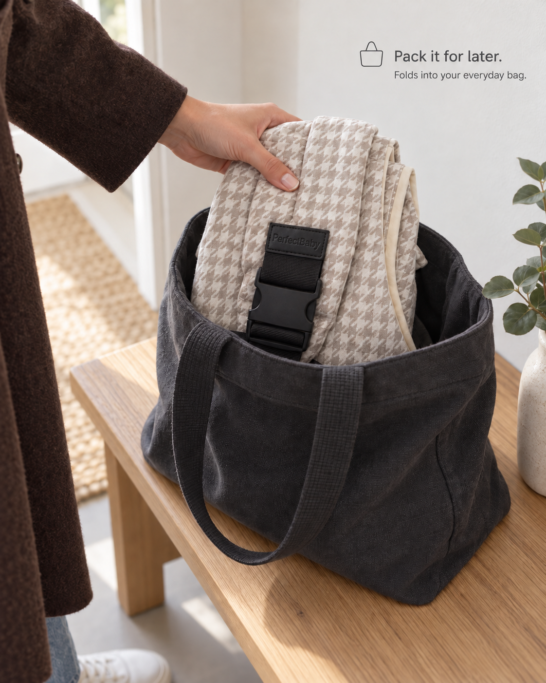 Folded KANGA Houndstooth Sand carrier placed in an everyday bag