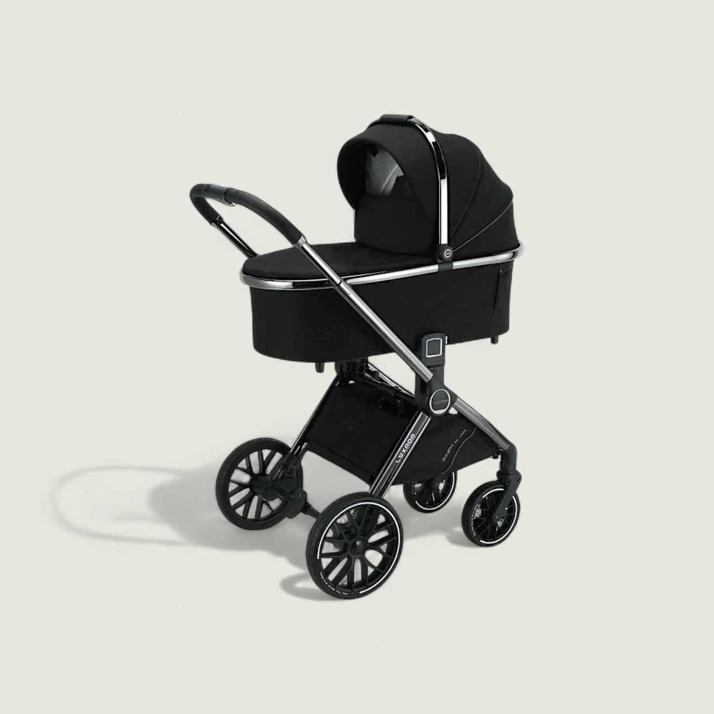 Black baby stroller on a light beige background
