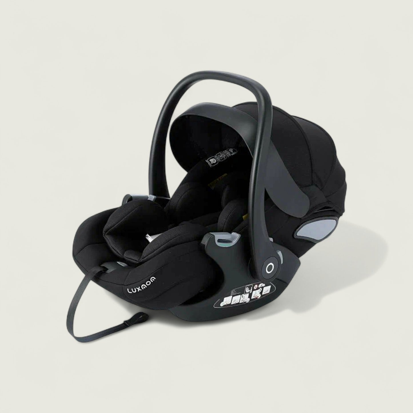 Black baby car seat with visible branding on a light beige background