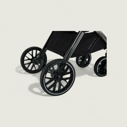 Black stroller on a beige background