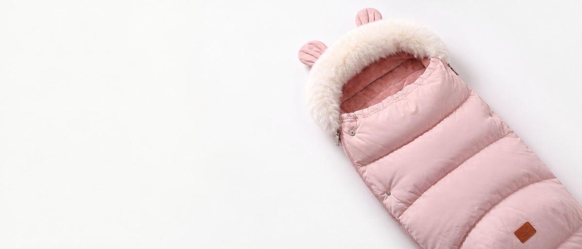 Pink BearWarm footmuff with ivory faux-fur trim on a white background