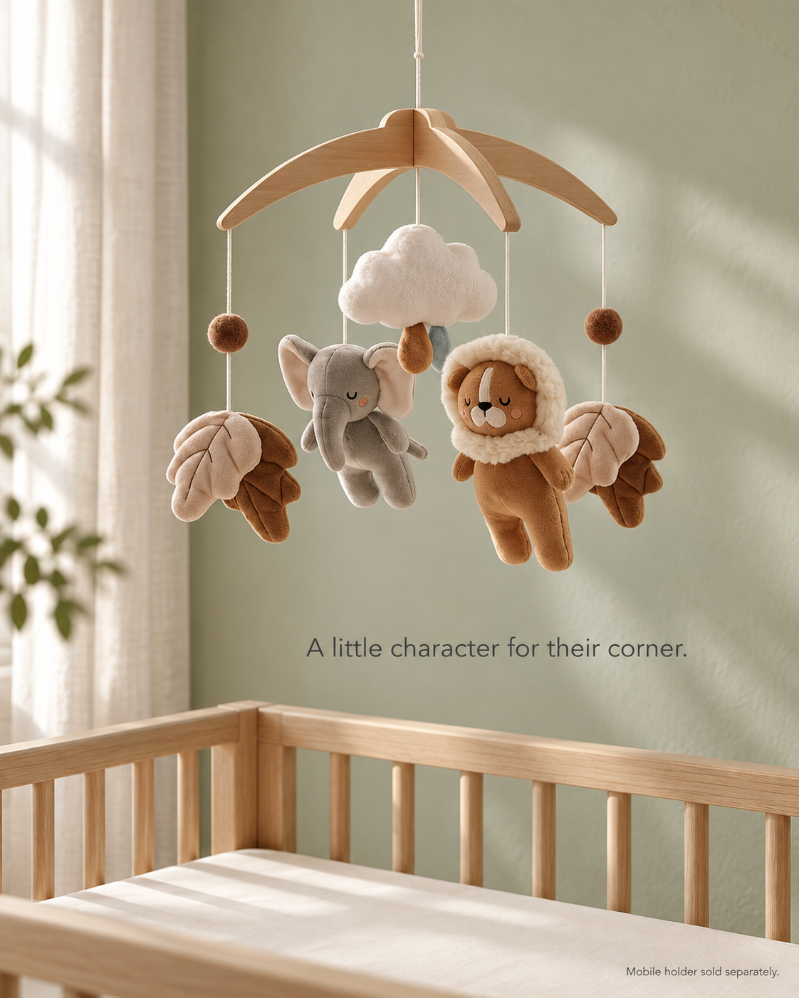 Elephant and Lion mobile in a softly lit nursery above an empty crib. Mobile holder sold separately.