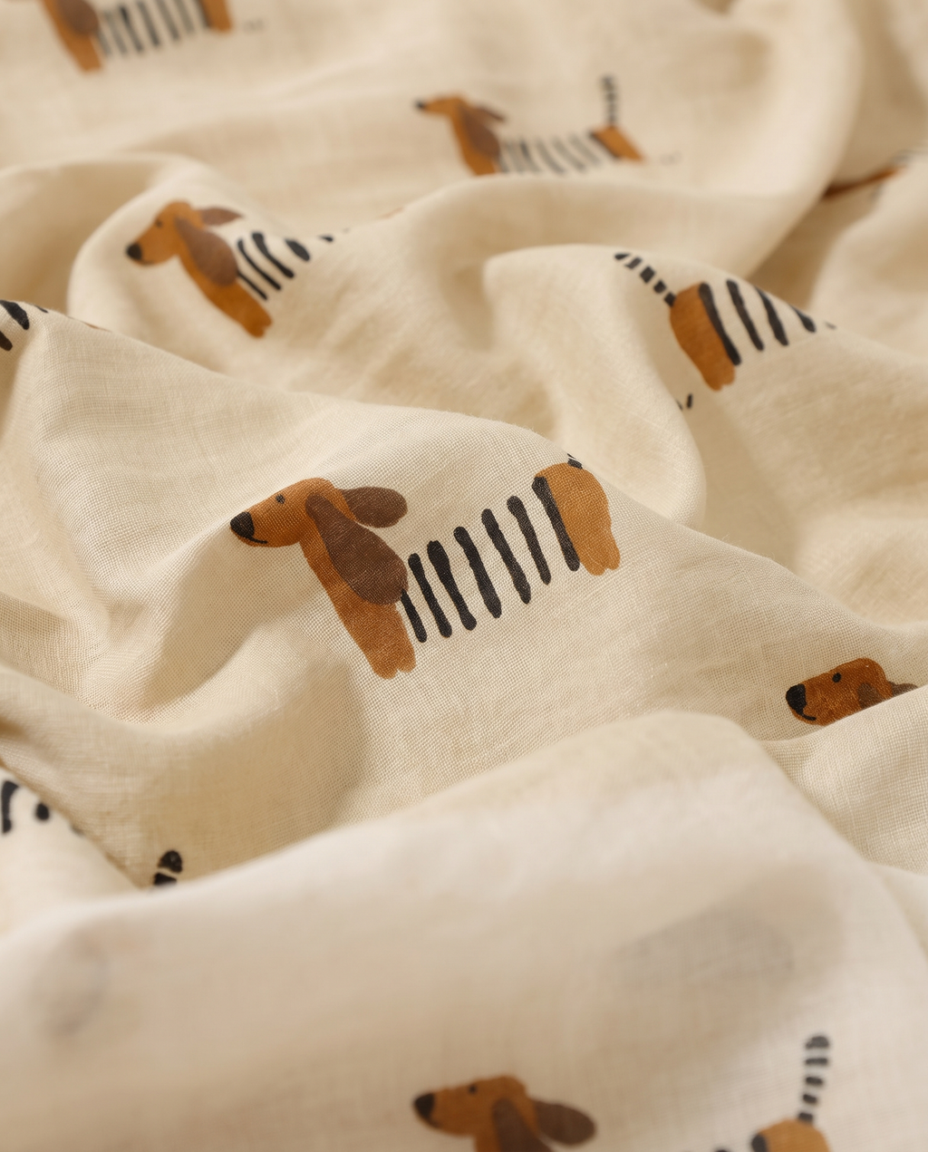Close-up of cotton muslin fabric with the Khaki Dachshund print